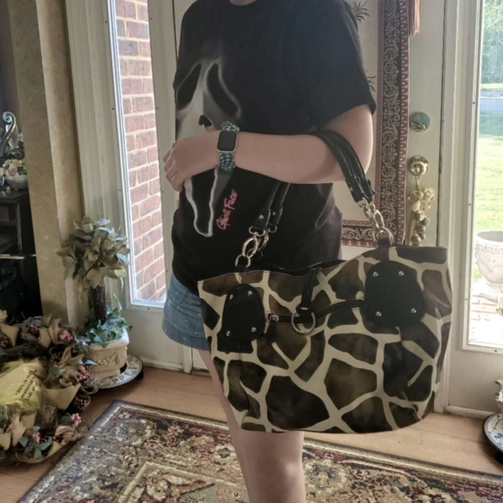 Large shoulder bag with brown and green cow print.